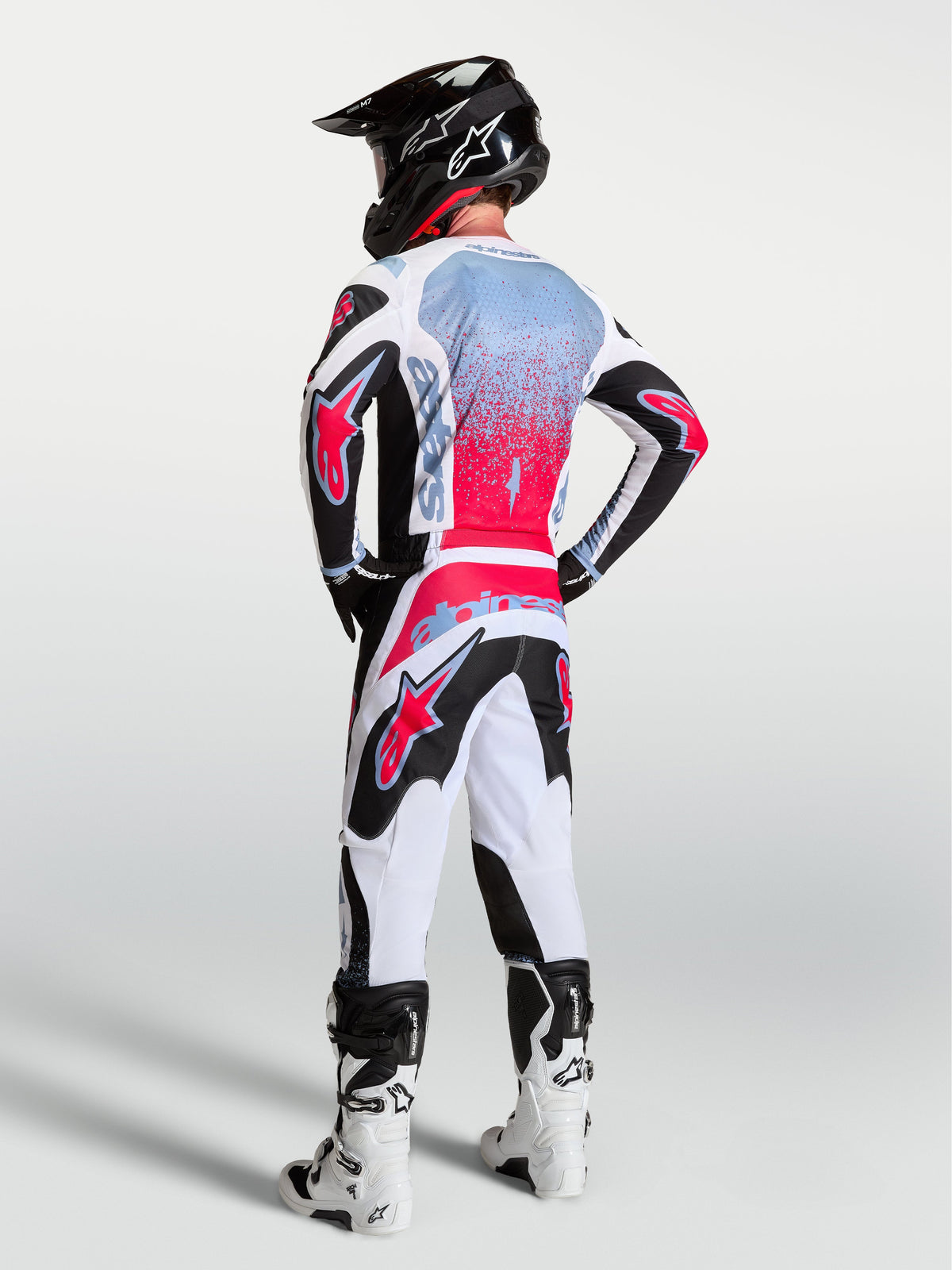 Alpinestars 2027 Fluid Drag Gear Set, black, white, and red men's motocross outfit with spray-effect graphics.