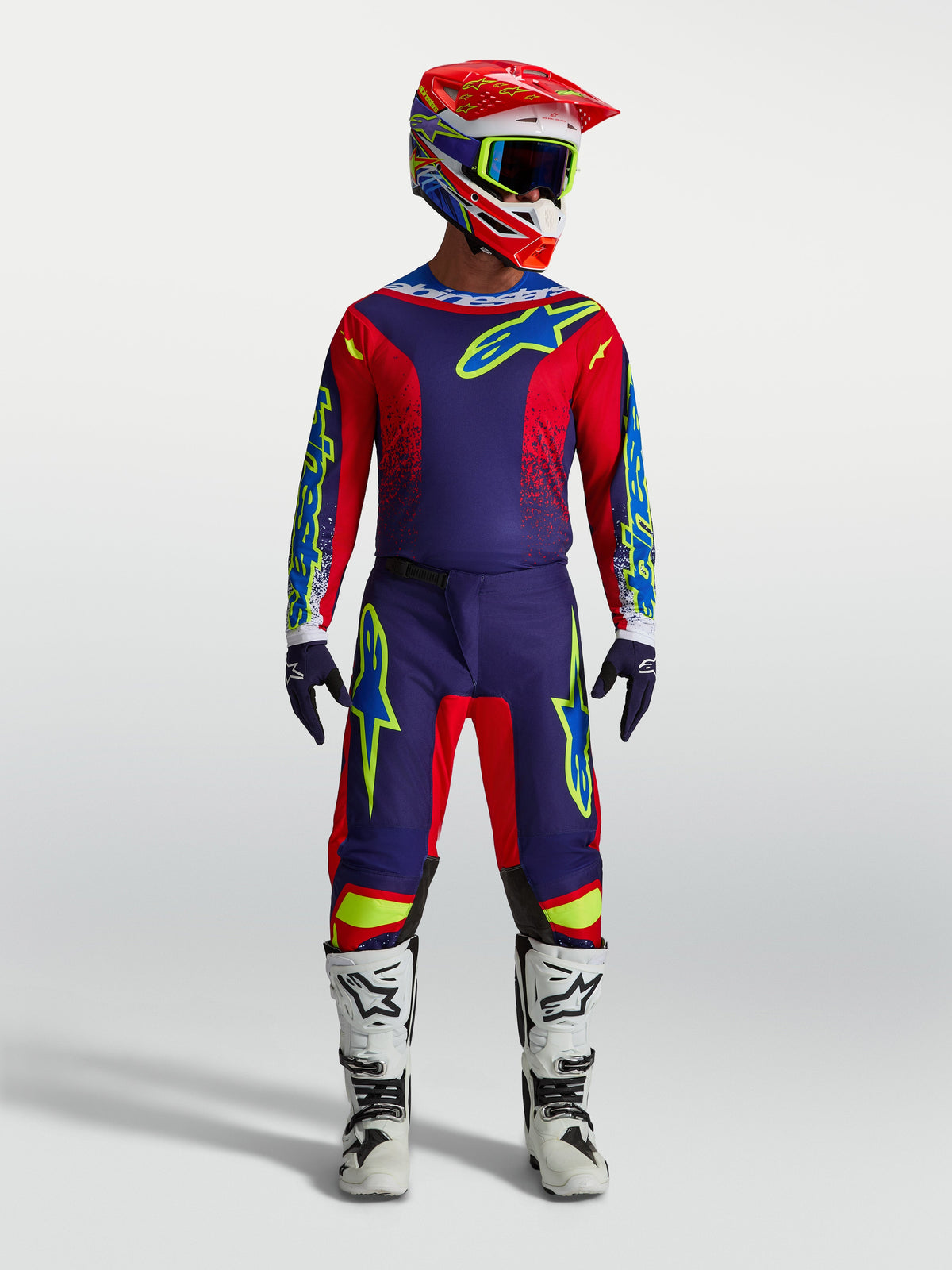 Alpinestars Fluid Drag Jersey AND Fluid Drag Gear Set, navy blue and fire red motocross outfit with white boots and helmet.