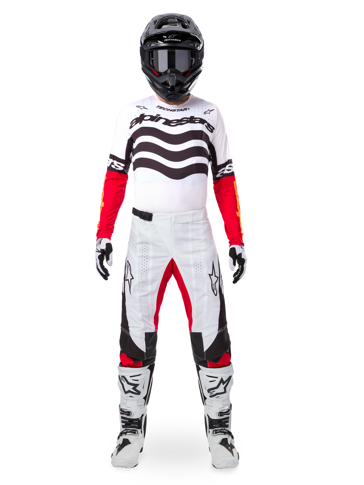 Motocross rider wearing the Alpinestars Limited Edition Techstar Deep Jersey in white, black, and red, featuring wavy chest graphics, paired with matching white and red pants, a black helmet, and white racing boots, full professional off-road gear setup.