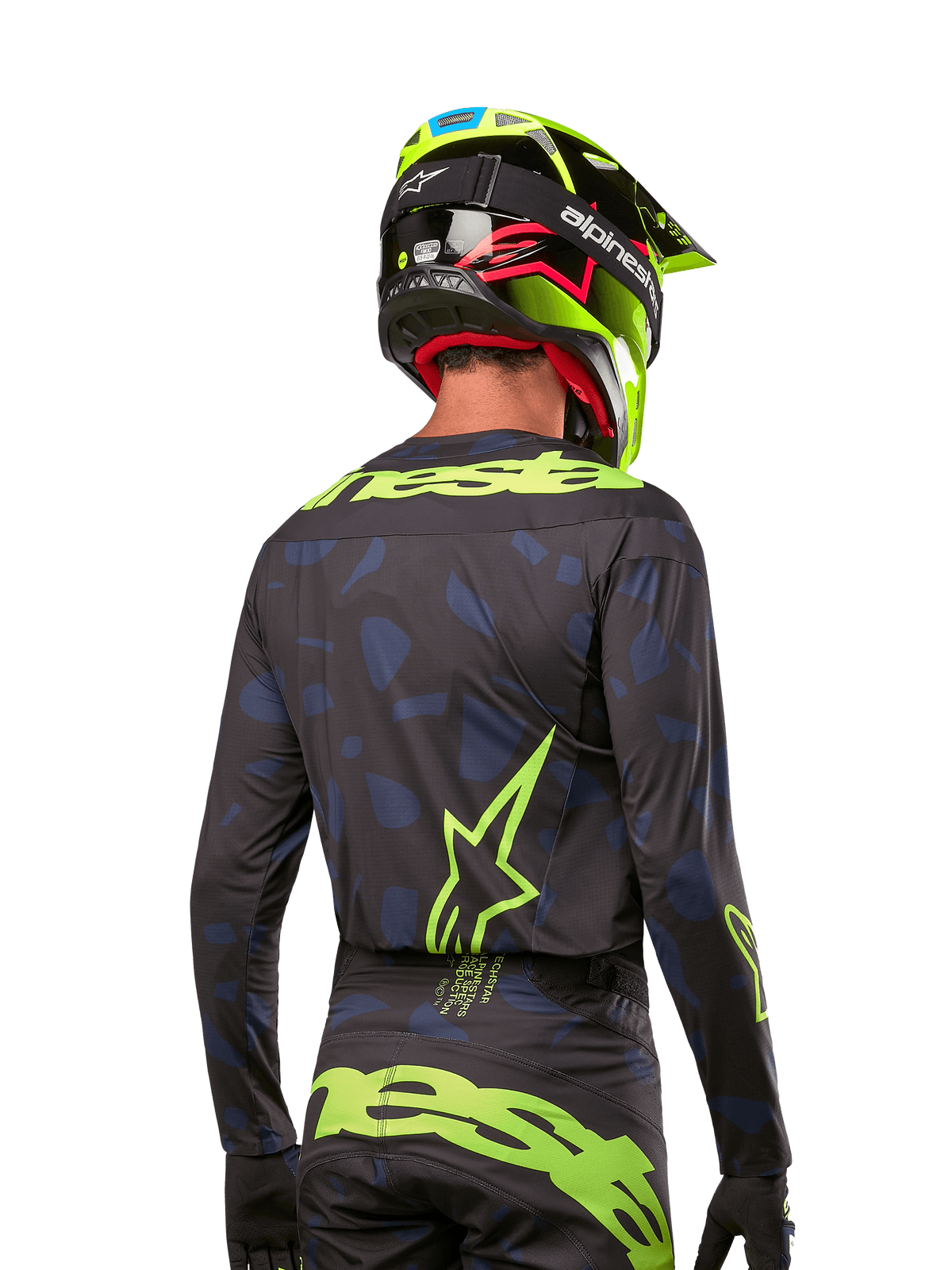 Rear view of a motocross rider wearing the Alpinestars 2024 Techstar Rantera Jersey in Black Navy Yellow Fluo, featuring prominent yellow fluo branding and logos on the back, paired with matching motocross pants and a neon yellow helmet for a complete off-road racing look.