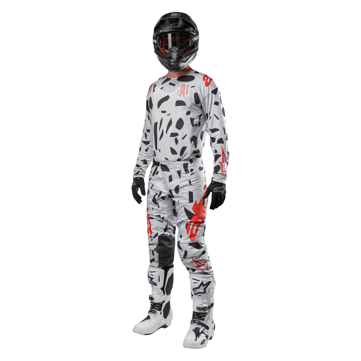Motocross rider wearing Alpinestars 2024 Techstar Rantera Jersey in Haze Gray Camo, matching pants with red and black accents, black helmet and goggles, black gloves, white and black boots, complete coordinated motocross racing gear for off-road performance
