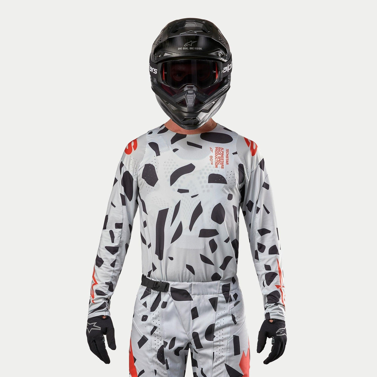 Alpinestars 2024 Techstar Rantera Jersey, Motocross Jersey, Haze Gray Camo with black irregular patterns and red accents, worn by a rider with matching pants, black helmet, and gloves, off-road racing gear.
