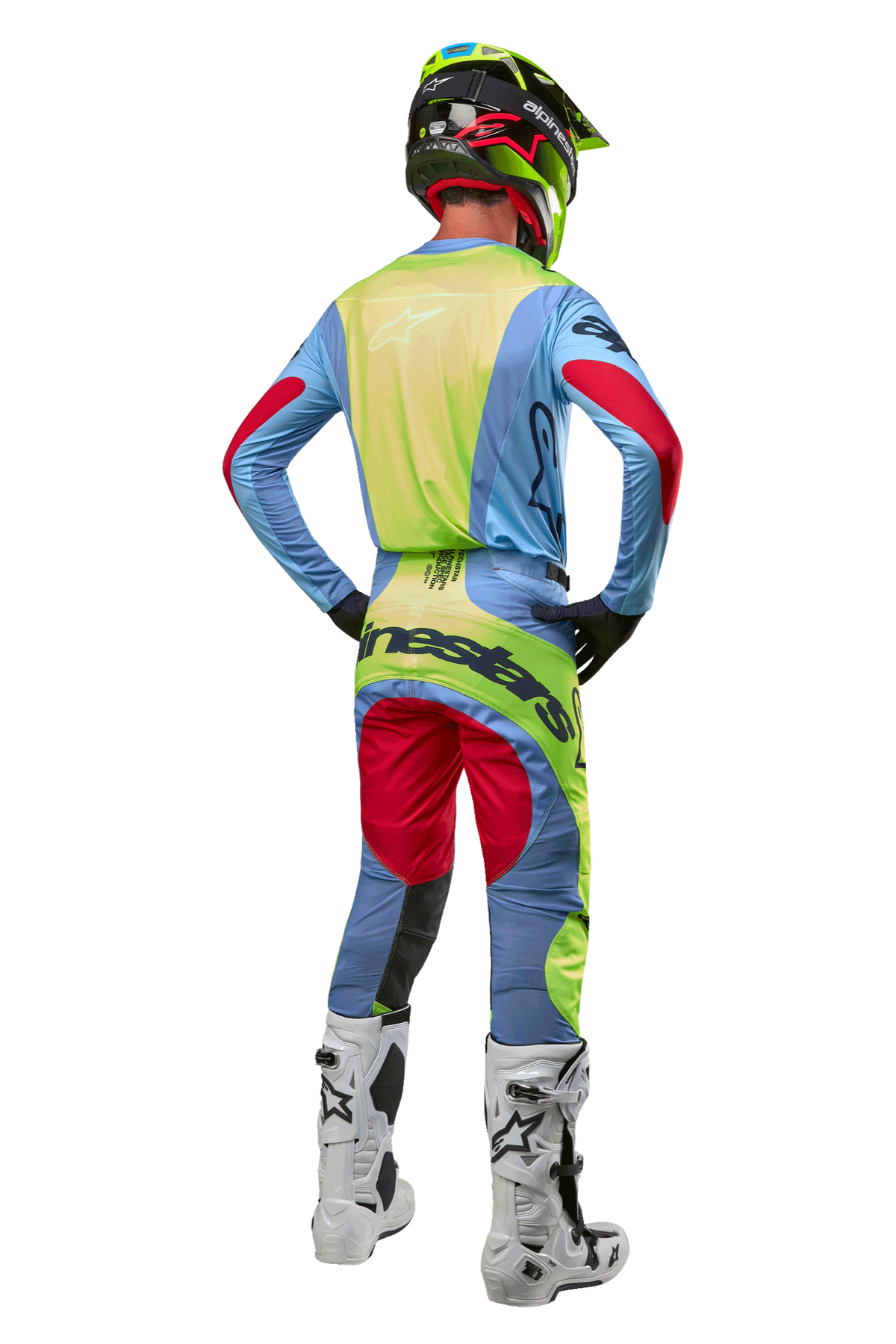 Motocross rider from the back wearing the Alpinestars 2024 Techstar Ocuri Jersey, Light Blue with Yellow Fluo and Red Berry accents, matching racing pants, white boots, and neon helmet, complete off-road gear for professional competition