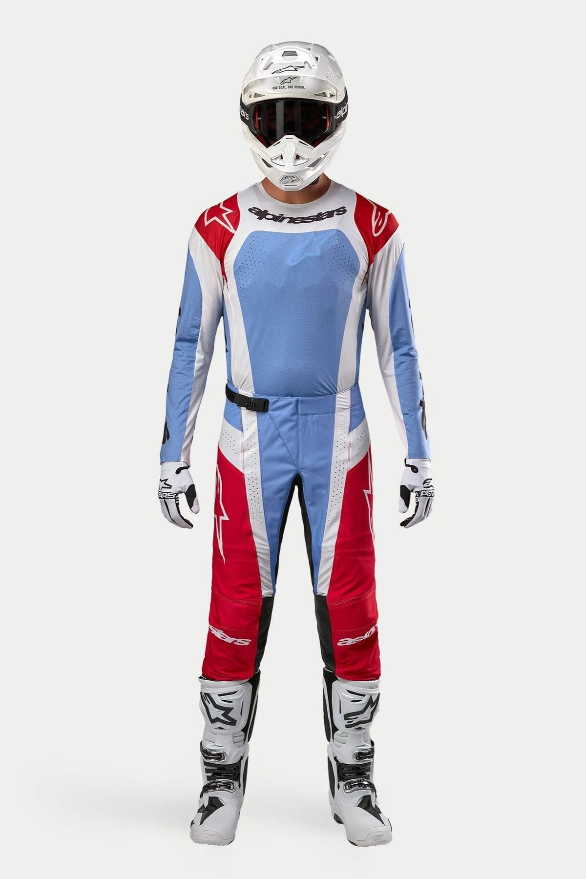 Motocross rider wearing 2024 Techstar Ocuri Jersey in Light Blue Mars Red White, matching motocross pants, white helmet with goggles, and white boots, complete professional off-road racing gear set