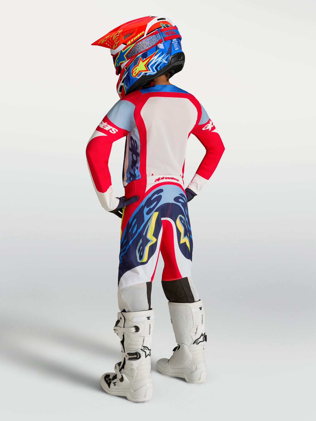Alpinestars Youth Supertech Dyna Motocross Gear Set, Fire Red and Navy Blue racing fit shown from a rear view.