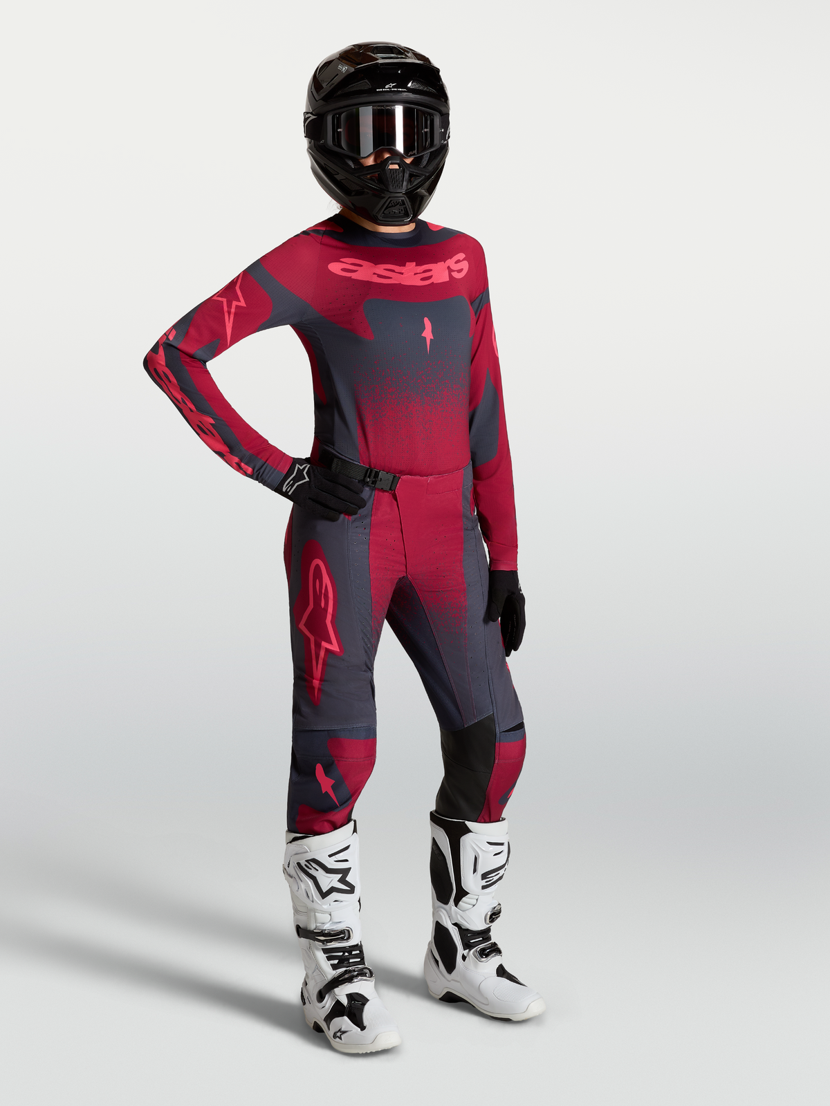 Alpinestars Stella Techstar Swan Pants and jersey, women's motocross outfit in crimson and dark gray with white racing boots.