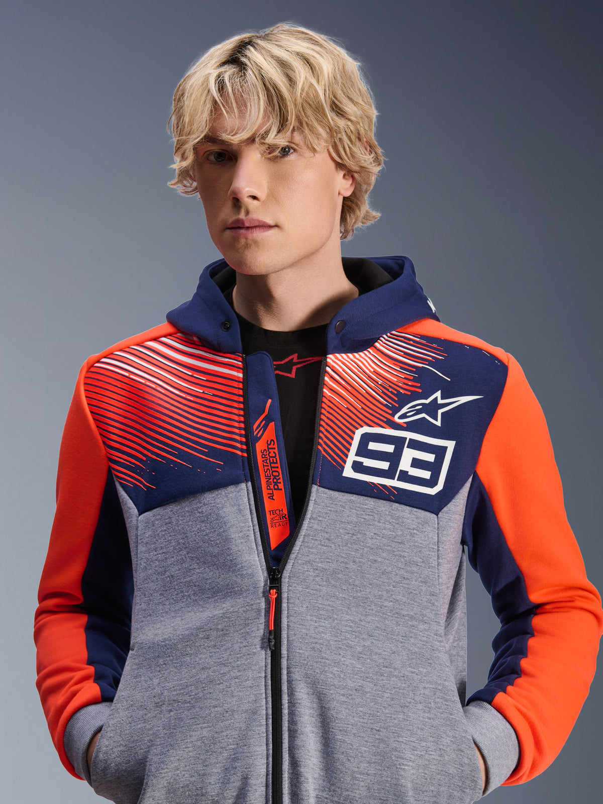 Alpinestars MM93 Chrome V2 Sport Hoodie, urban motorcycle hoodie, Blue Navy and Gray Mel with Red Fluo accents, featuring Marc Marquez 93 branding and Alpinestars logo, full-zip design, casual lifestyle apparel for riders