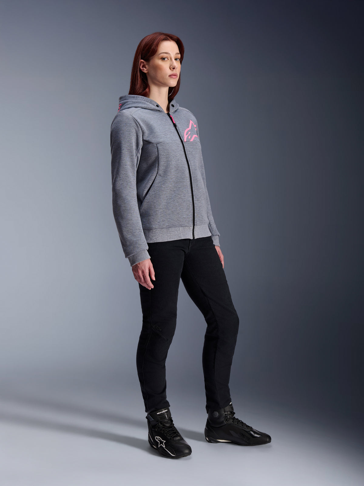 Alpinestars Stella Chrome V2 Sport Hoodie, Women's Motorcycle Hoodie, Gray Heather and Pink Fluo, worn with black riding pants and black boots, casual urban riding gear