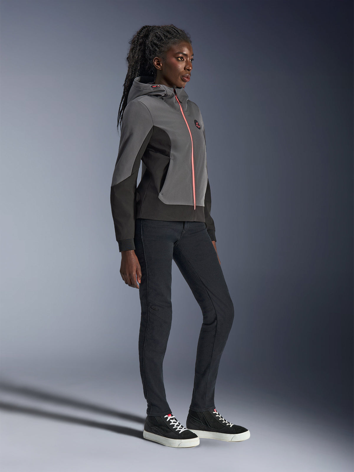 Alpinestars Stella Radium Tech Hoodie, urban motorcycle riding hoodie, Deep Gray and Black with bright orange zipper, worn with black pants and black sneakers, women-specific athletic fit