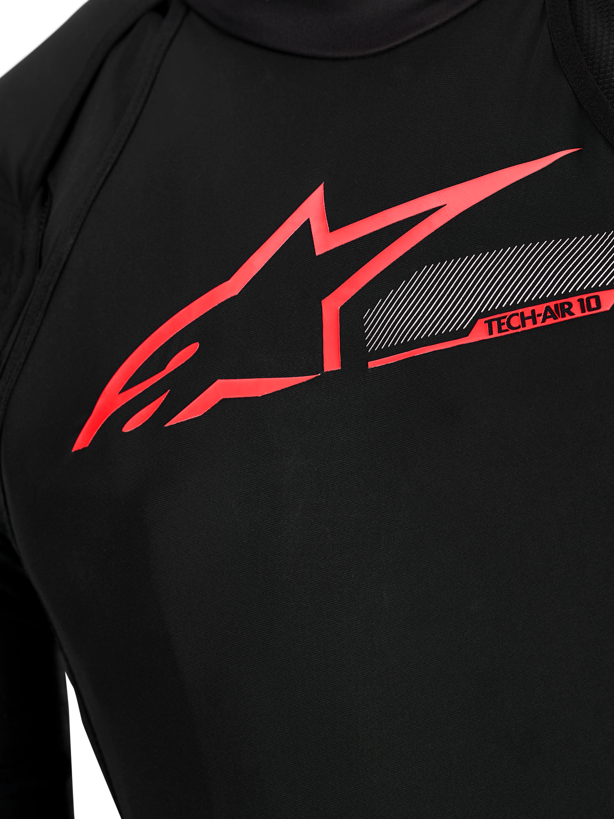 Tech-Air 10 V2 Race Airbag System chest detail, black technical fabric with bright red Alpinestars logo and tech graphics.