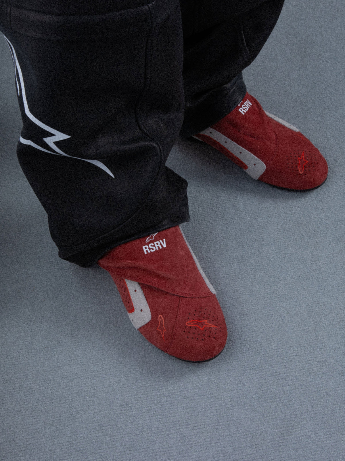 Alpinestars RSRV Starline Shoes, Red lifestyle slippers with white and gray accents, RSRV branding, soft texture, worn with black pants, casual urban footwear