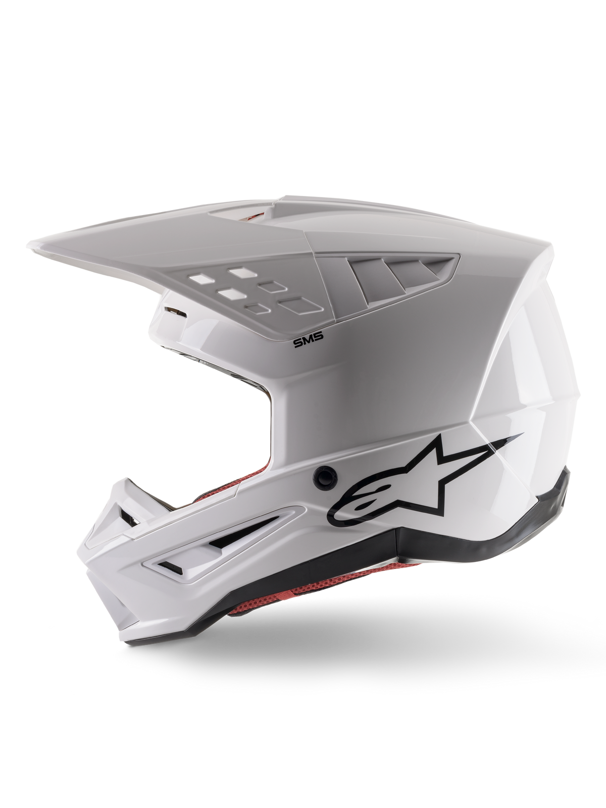 Alpinestars S-M5 Solid Helmet ECE 22.06, Motocross Helmet, White Glossy, side profile view with angular shell design, black Alpinestars logo on the side, multiple ventilation ports, and integrated visor for off-road racing.