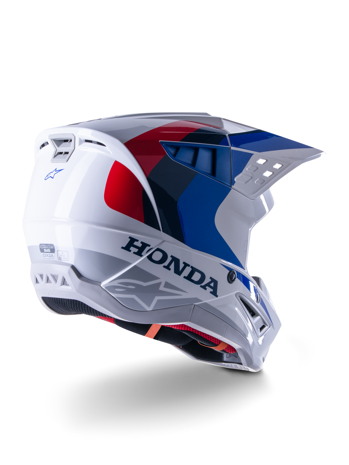 Alpinestars Honda S-M5 Helmet ECE, Motocross Helmet, White Blue and Red Glossy, featuring bold Honda branding and Alpinestars logos, aerodynamic shell with integrated ventilation ports and adjustable visor, protective gear for off-road racing
