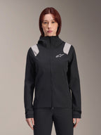 Alpinestars Stella A-Dura Rain Jacket, Women's Cycling Rain Jacket, Black with light gray shoulder panels, hooded technical shell with white logo on chest, adjustable Velcro cuffs, professional gear for MTB and wet weather riding