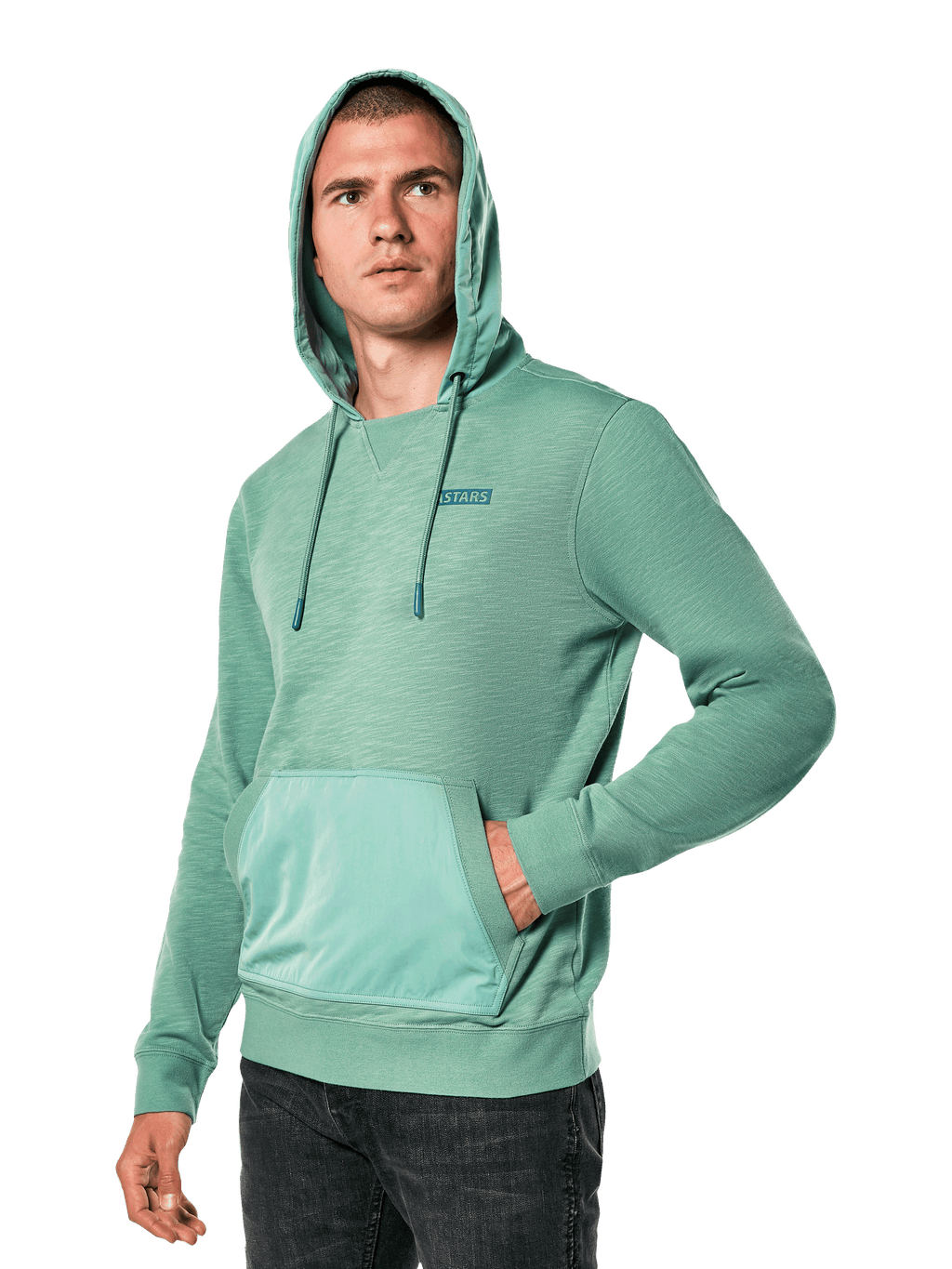 Alpinestars Rooted Hoodie, Green slub French terry sweatshirt with overlay hood and kangaroo pocket, small STARS logo on chest, worn by a model with hood up and hand in pocket, casual motorsport-inspired streetwear