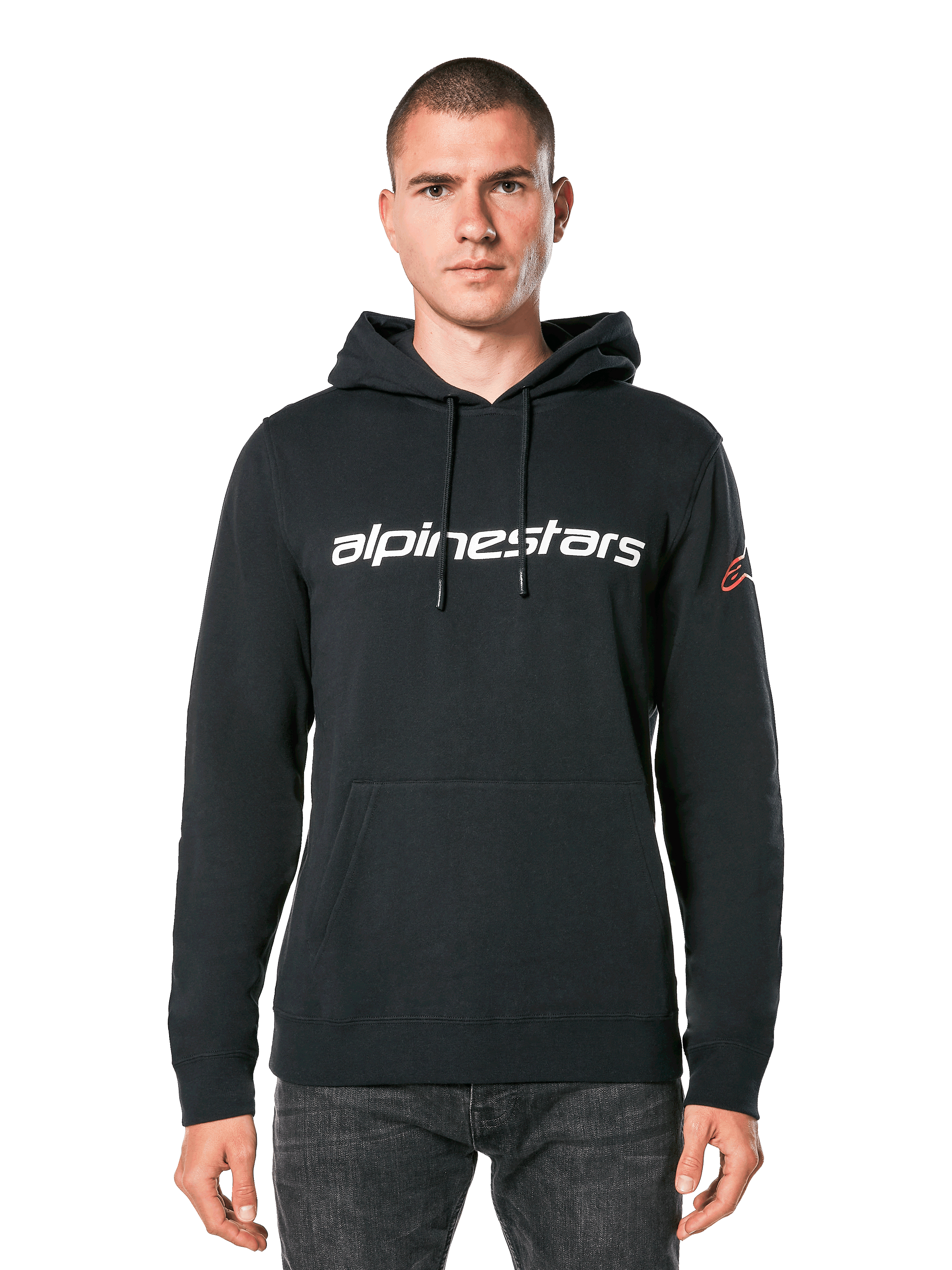 Alpinestars Linear Wordmark V3 Hoodie, Black Pullover Hoodie, White Alpinestars wordmark on chest, Red Ageless sleeve logo, front kangaroo pocket, drawstring hood, worn by a male model, casual motorsport-inspired streetwear