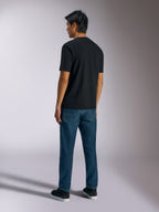 Alpinestars Ageless Shadow CSF Tee, Short Sleeve T-Shirt, Black, Back View, worn with blue jeans and black sneakers, casual motorsport-inspired streetwear