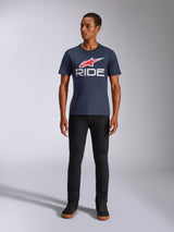 Alpinestars Ride 4.0 CSF Tee, Short Sleeve T-Shirt, Navy Blue with red Alpinestars star logo and white 'RIDE' text on the chest, worn by model with black pants and black sneakers, casual motorsport-inspired streetwear