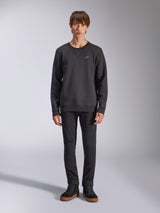 Alpinestars Positive Crew Sweatshirt, Casual Black Crewneck, Small White Logo on Chest, V-stitch Neckline, Full-Body Studio Shot with Model wearing Black Pants and Sneakers, Motorsport-Inspired Lifestyle Apparel