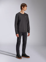 Alpinestars Positive Crew, Pullover Sweatshirt, Black, small white Alpinestars logo on the chest, ribbed collar with V-stitch detail, ribbed cuffs and hem, worn by a model with black trousers and sneakers, casual motorsport-inspired streetwear