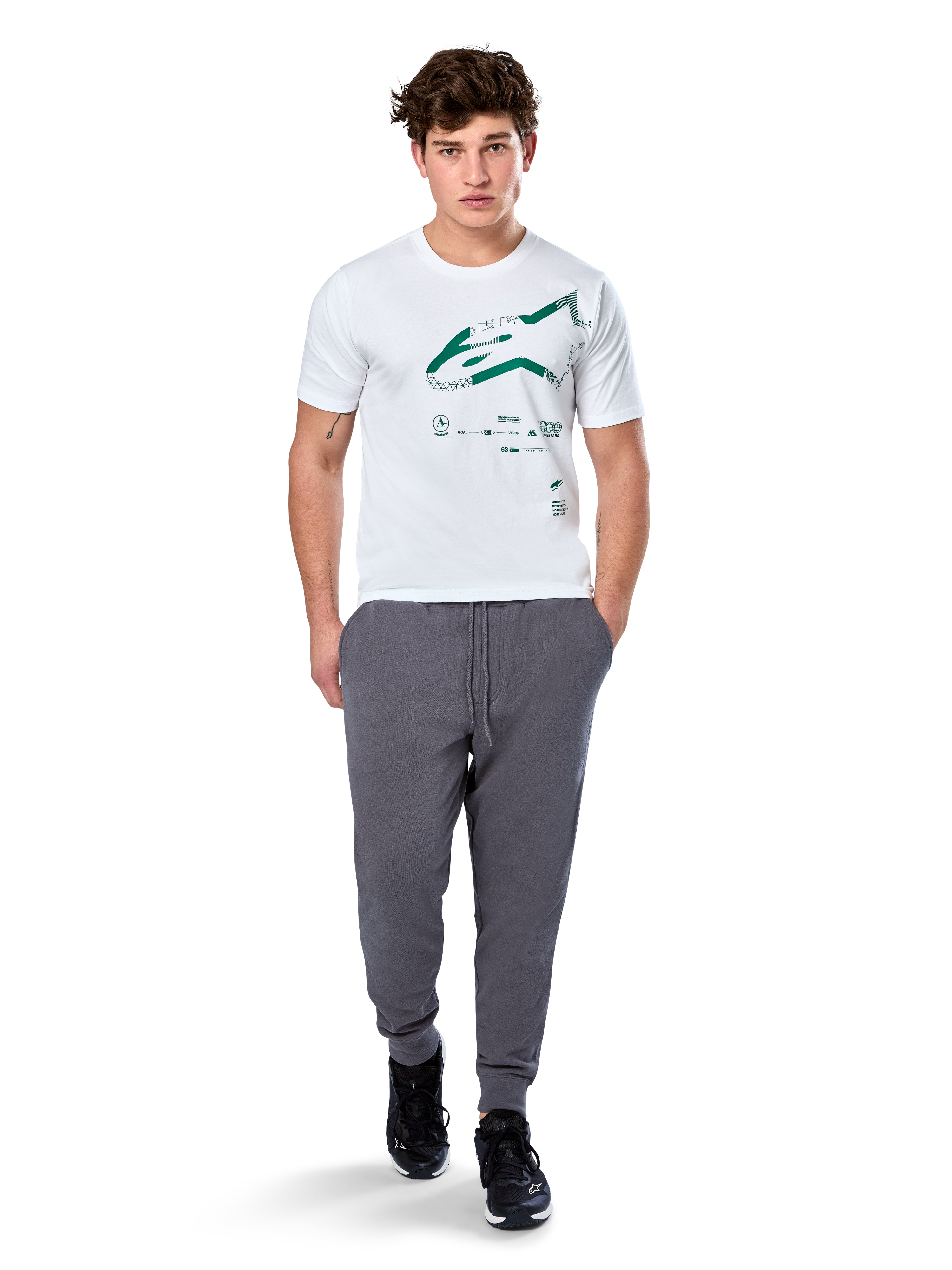 Alpinestars Geografica CSF Tee, Short Sleeve T-Shirt, White, Green Astars Logo with geographic multi-tech graphic, worn with grey sweatpants and black sneakers, casual motorsport streetwear