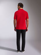 Alpinestars Endeavor Classic Polo, Red Pique Polo Shirt, back view, worn with black pants, casual motorsport streetwear featuring ribbed collar and sleeve cuffs