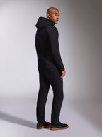 Alpinestars Ellipsoid Hoodie, black casual streetwear, back view on male model, hooded pullover fleece with rib cuffs and hem, worn with black pants and sneakers, modern motorsport-inspired design