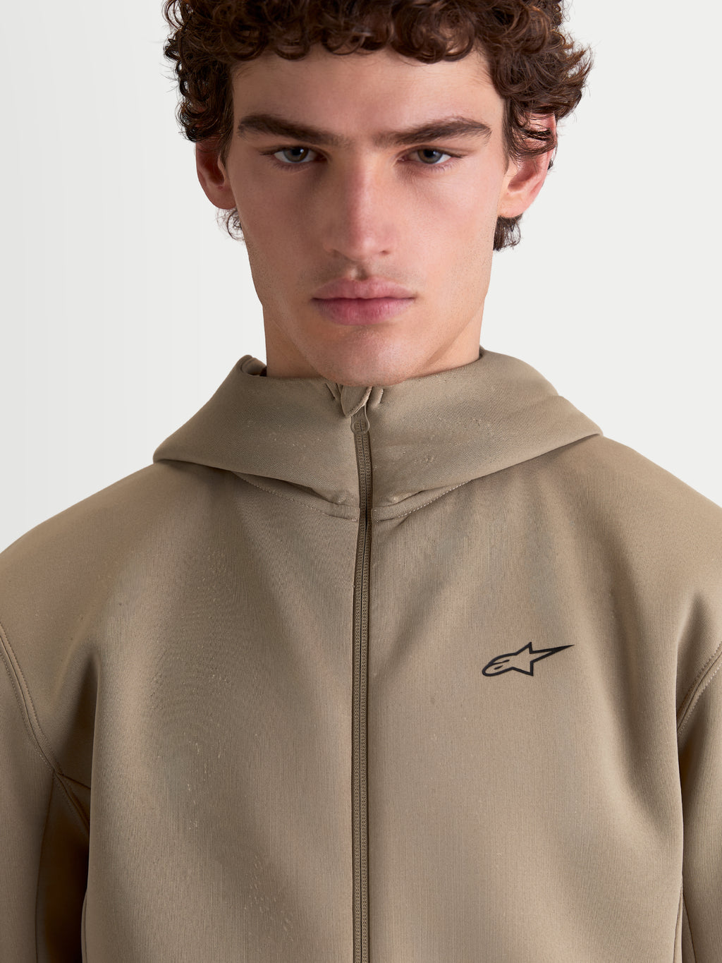 Alpinestars Cypher Hoodie, Sportswear Full-Zip Fleece for Men and Women, Putty Beige, featuring a high-neck hood, technical tri-blend double-face fabric, and a minimalist Alpinestars logo on the chest.