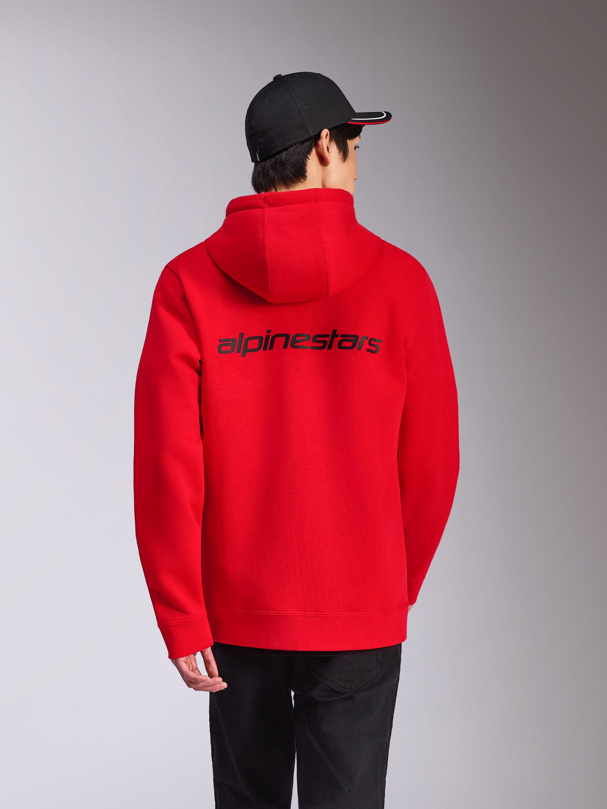 Alpinestars Transverse Hoodie, Red, rear view featuring black Alpinestars wordmark across the back, casual streetwear, hooded fleece with ribbed cuffs and hem, styled with a black cap