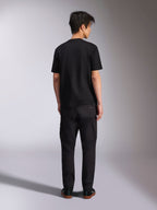 Alpinestars Noka CSF Tee, Short Sleeve T-Shirt, Black, back view of model wearing the tee with black pants and sneakers, casual motorsport streetwear style