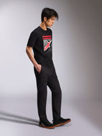 Alpinestars Noka CSF Tee, Short Sleeve T-Shirt, Black, Front Astars Logo with red and white MX gradation, worn with black cargo pants and sneakers, casual motorsport-inspired streetwear