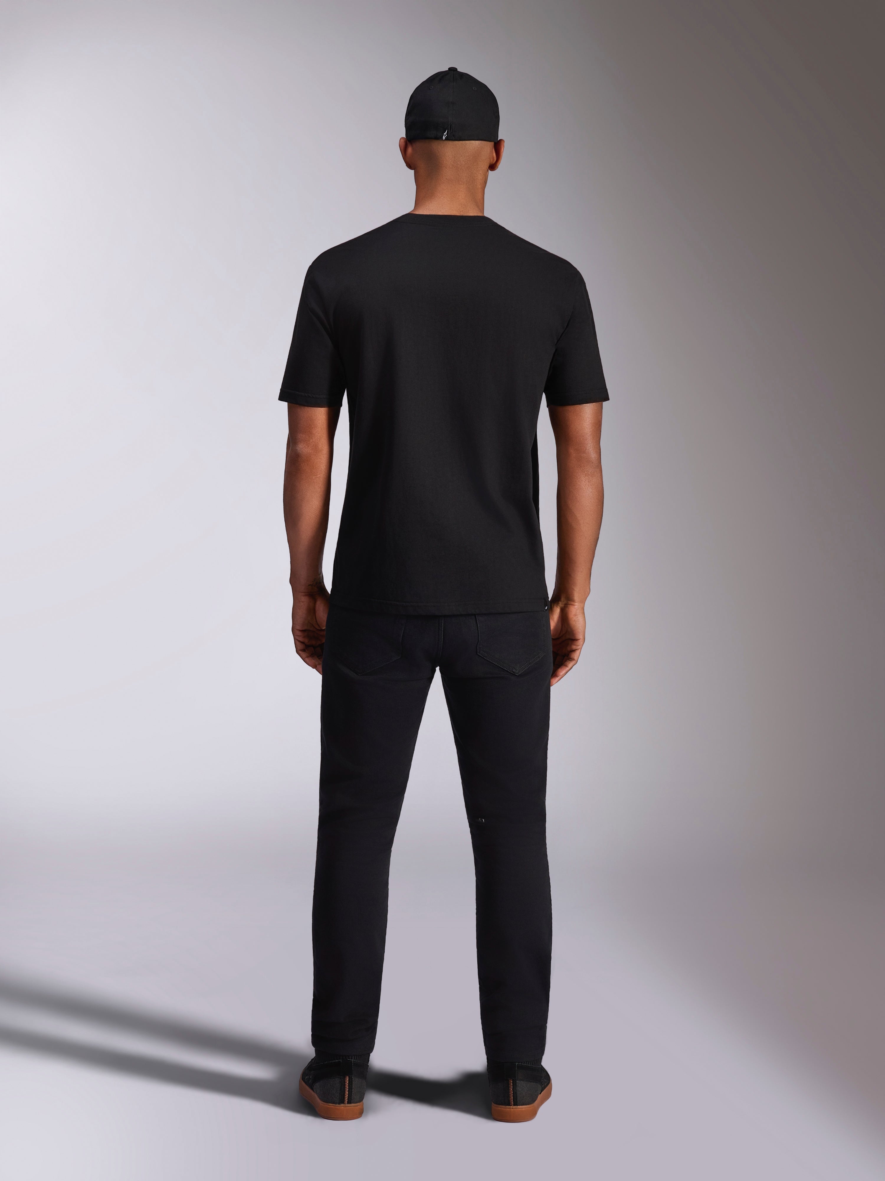Alpinestars Ellipsoid CSF Tee, Short Sleeve T-Shirt, Black, Back view worn by model with black cap and pants, casual motorsport-inspired streetwear
