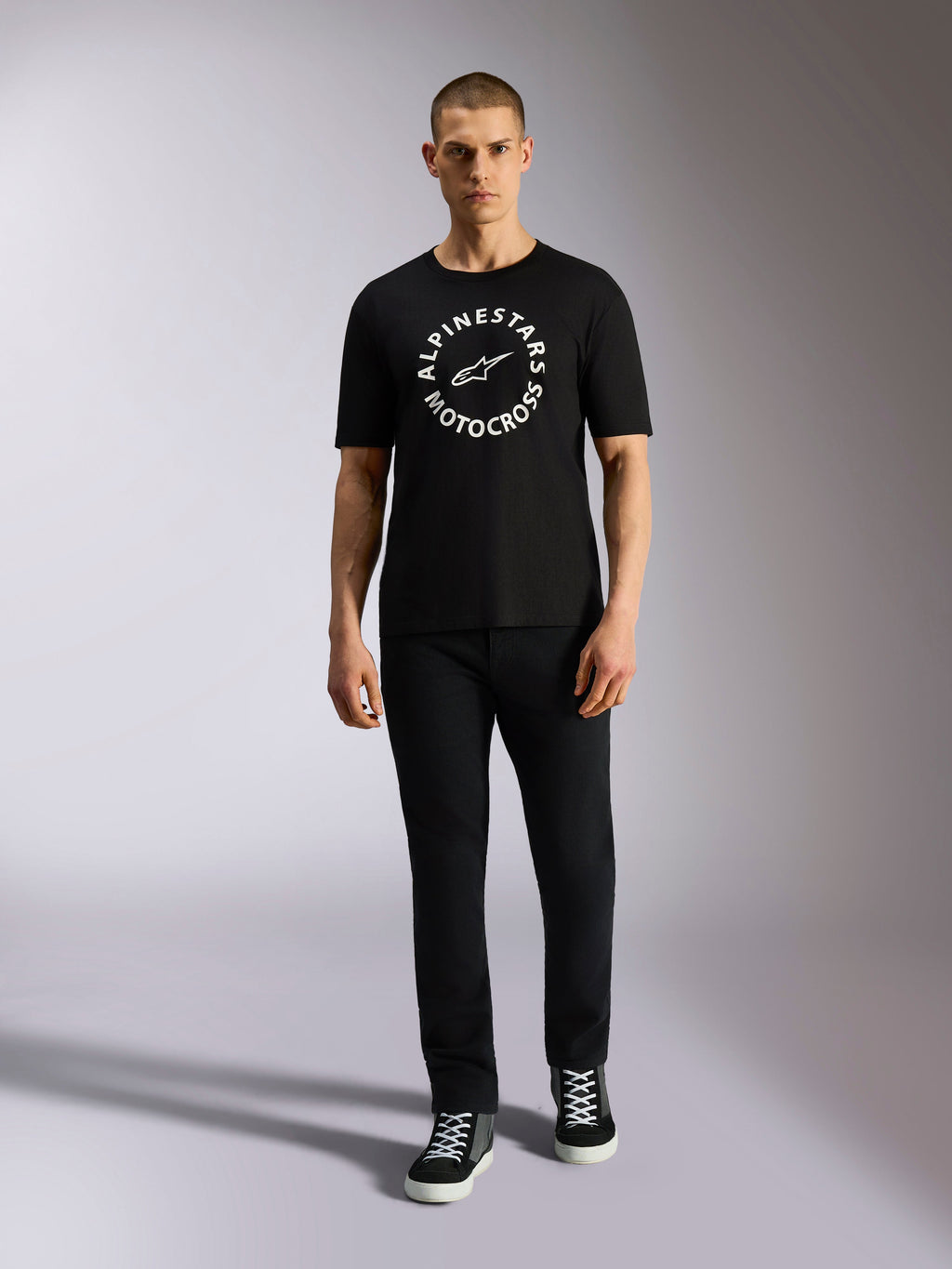 Alpinestars MX CSF Tee, Short Sleeve T-Shirt, Black, White circular Alpinestars Motocross graphic, worn by model with black pants and sneakers, casual motorsport streetwear