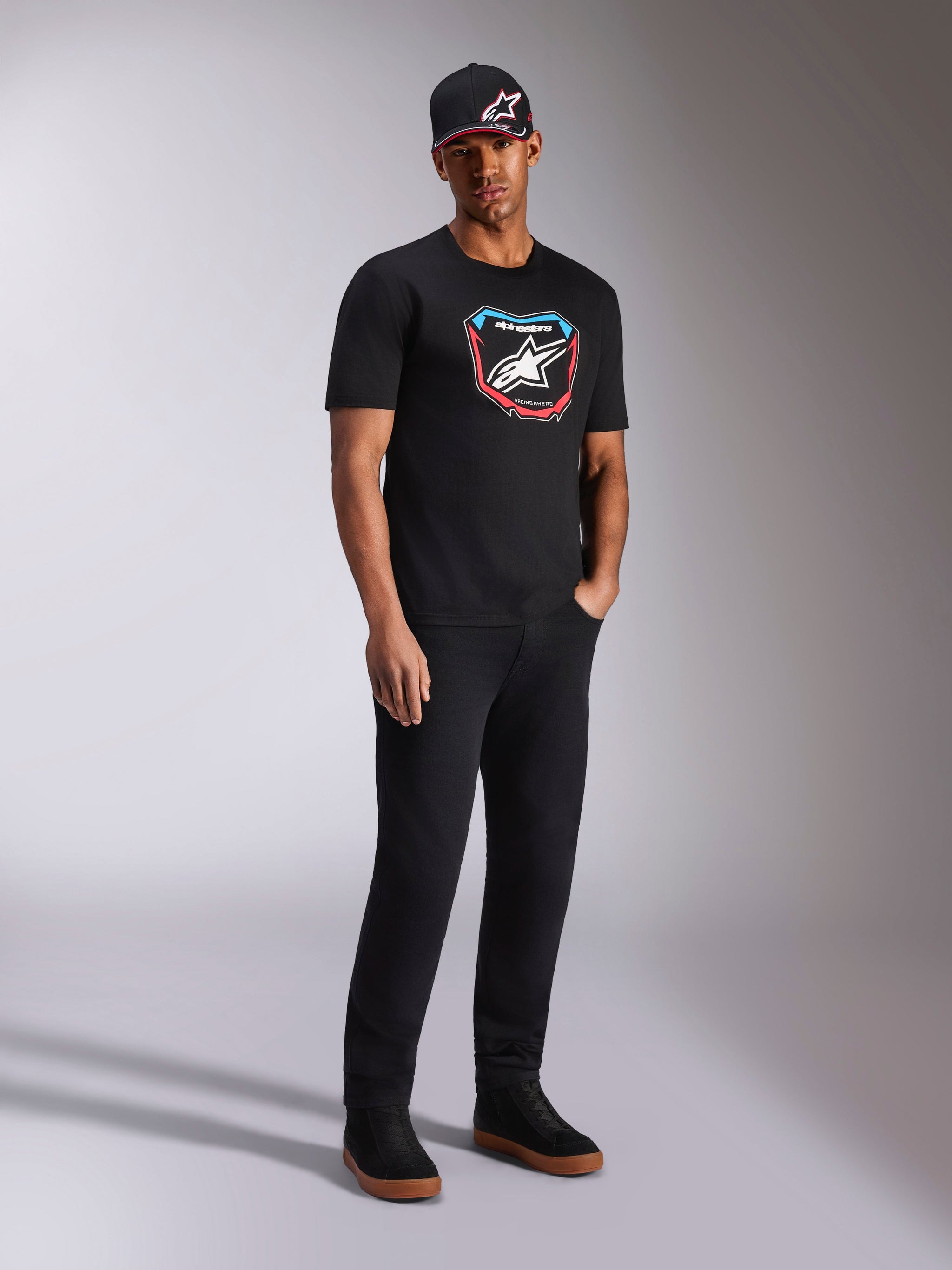 Alpinestars Plate CSF Tee, Short Sleeve T-Shirt, Black, colorful front MX plate graphic with star logo, worn by model with black logo cap and pants, casual motorsport-inspired streetwear