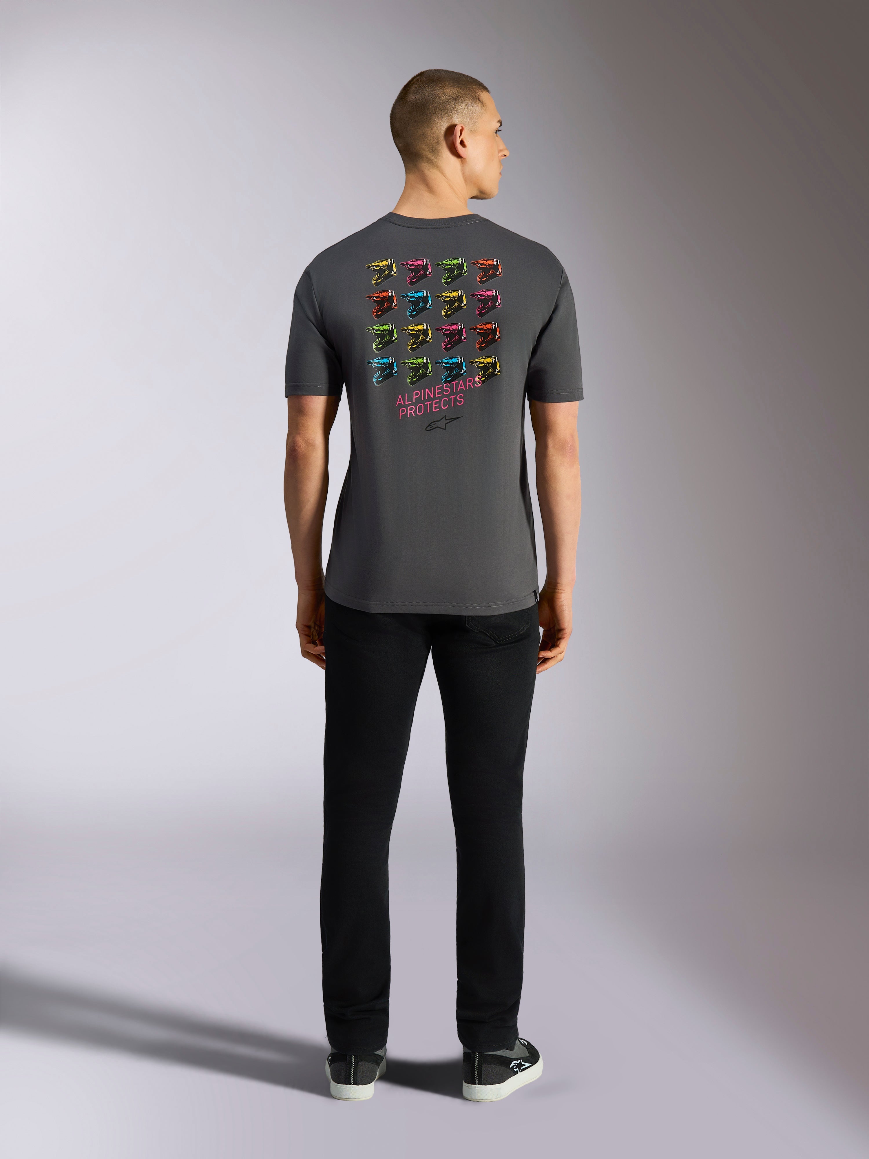 Alpinestars Pop Helmet CSF Tee, Short Sleeve T-Shirt, Charcoal Gray, featuring a grid of multi-colored M10 helmet graphics on the back with 'ALPINESTARS PROTECTS' text, Casual Motorsport Streetwear