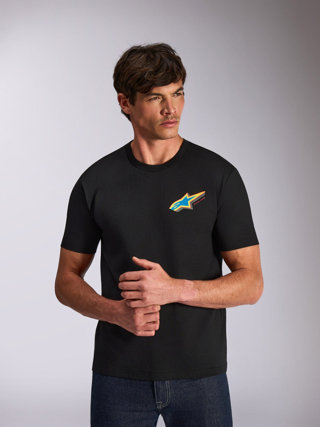 Alpinestars Angler CSF Tee, Short Sleeve T-Shirt, Black, vibrant multi-color Astars star logo on chest, casual motorsport-inspired streetwear worn by model
