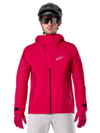 Alpinestars A-Dura Elite Waterproof Jacket, Mountain Bike Rain Jacket, Red Fluo, high collar with white Alpinestars logo, black zipper details, worn with matching gloves and black cycling helmet, technical waterproof cycling gear