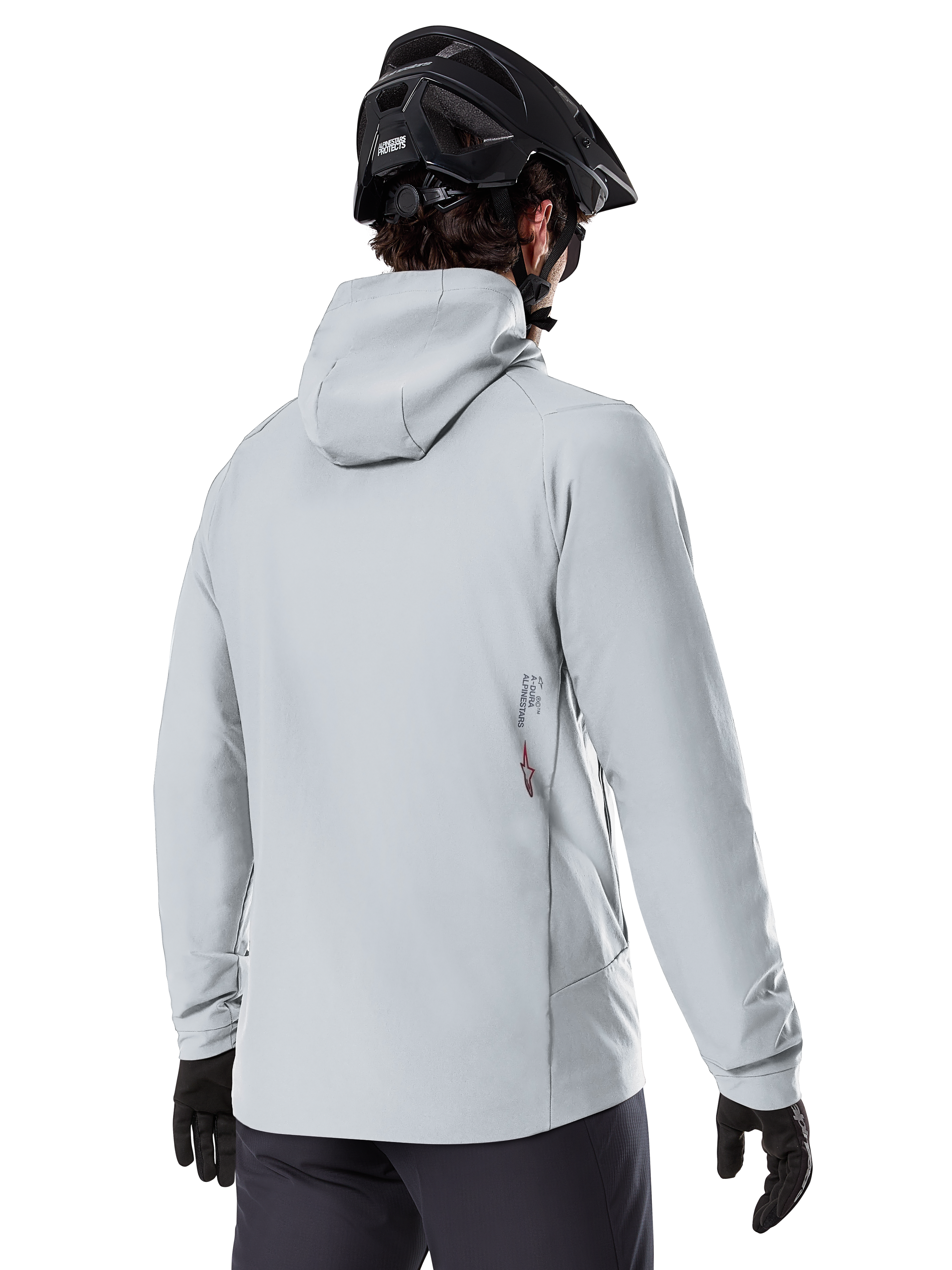 Alpinestars A-Dura Thermal Jacket, Titanium Gray, back view of a rider wearing the hooded insulated jacket, paired with a black MTB helmet and black gloves, featuring a small Alpinestars logo on the lower back, designed for cold-weather mountain biking.