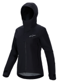 Alpinestars Stella A-Dura Elite Waterproof Jacket, Women's Mountain Bike Jacket, Black, featuring a hooded design with a protective storm flap, front zipper, zippered hand pockets, and adjustable velcro cuffs, technical waterproof fabric with a silver logo on the chest