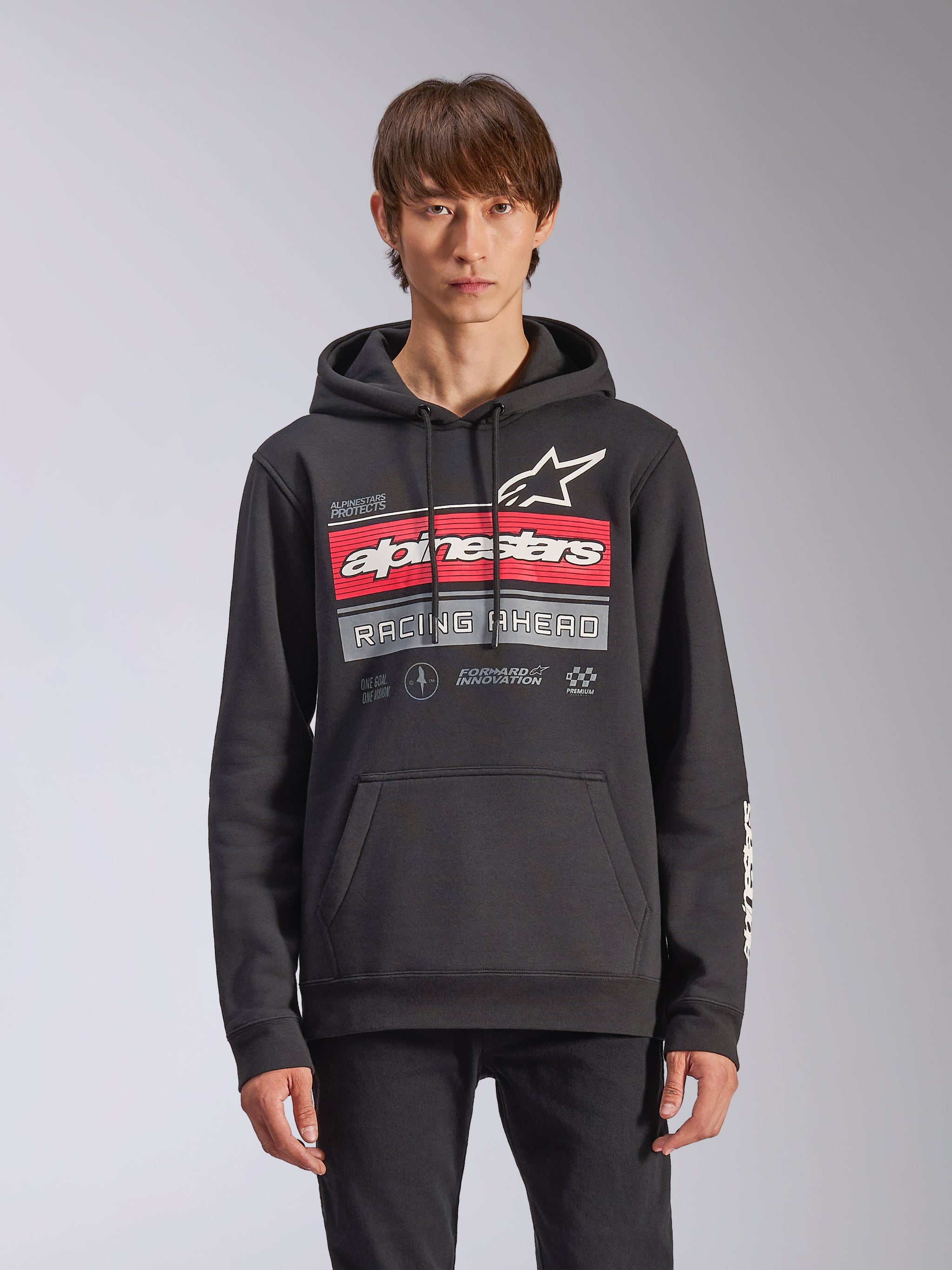 Alpinestars Harken Hoodie, Black Pullover Fleece Hoodie, featuring a red and grey gradation graphic with Alpinestars logo and 'Racing Ahead' text, kangaroo pocket, drawstring hood, and sleeve branding, casual motorsport-inspired design