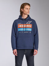 Alpinestars Harken Hoodie, casual streetwear, Navy blue with 'Racing Ahead' chest graphic in orange and light blue, pullover fleece hoodie with kangaroo pocket and drawstring hood, worn by model with dark jeans