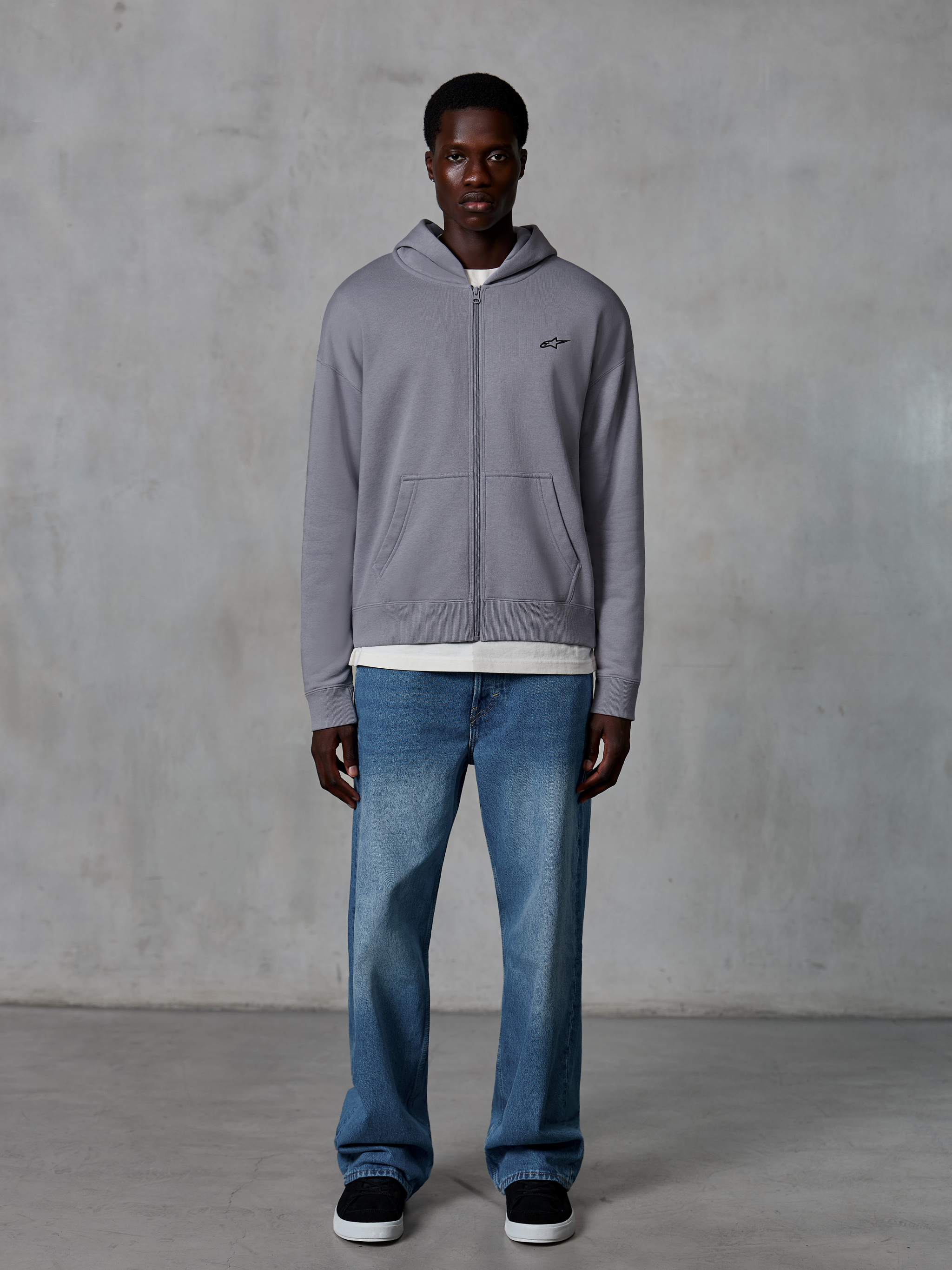 Alpinestars Essentials Ageless Zip Hoodie, Silver, casual streetwear, full-zip fleece with small black Alpinestars logo on chest, worn with blue jeans and white undershirt, relaxed fit motorsport-inspired design