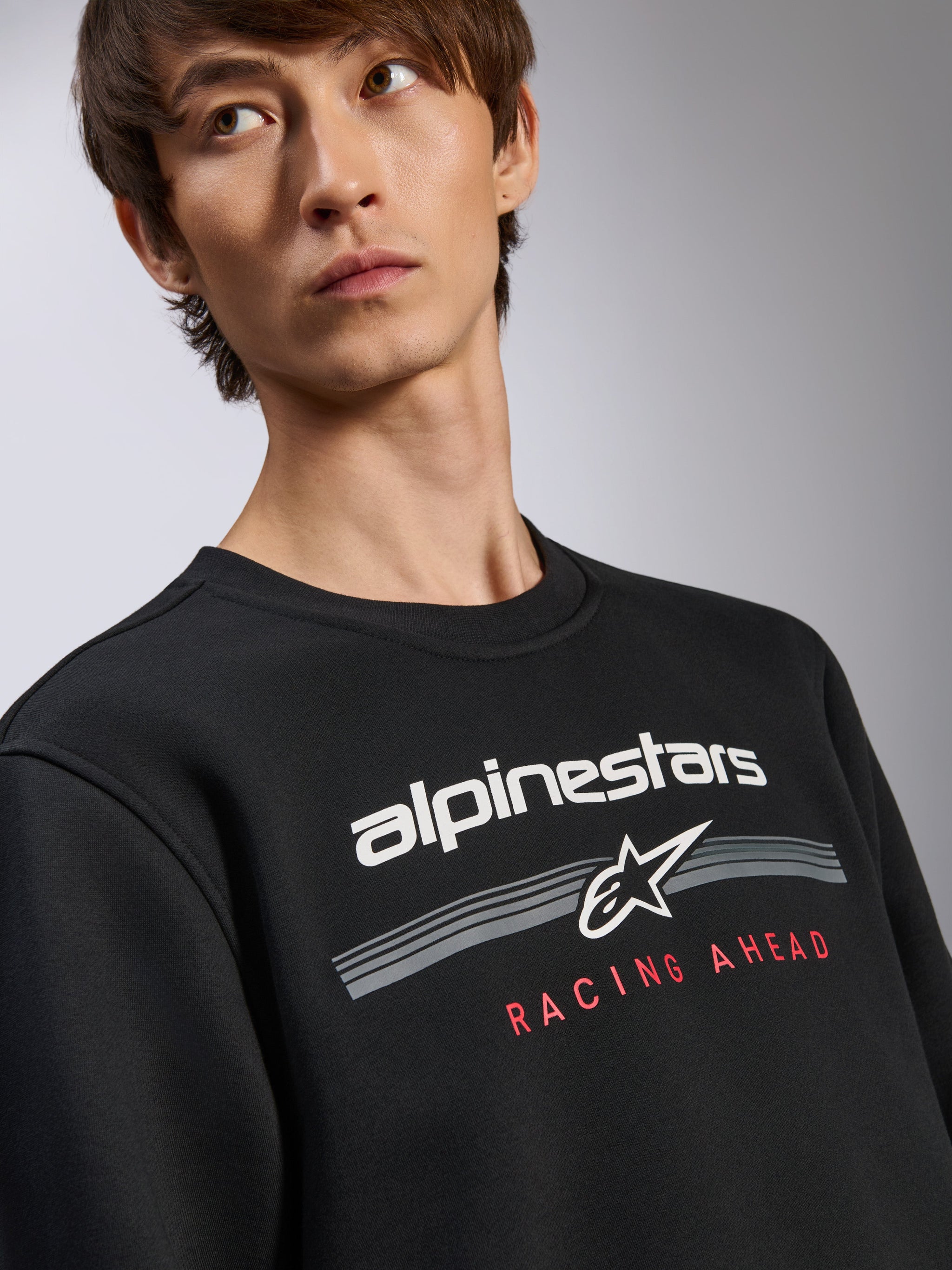 Alpinestars Bettern Crew Pullover, Black Sweatshirt, White Alpinestars logo with 'Racing Ahead' red text graphic, crew neck, casual motorsport-inspired streetwear