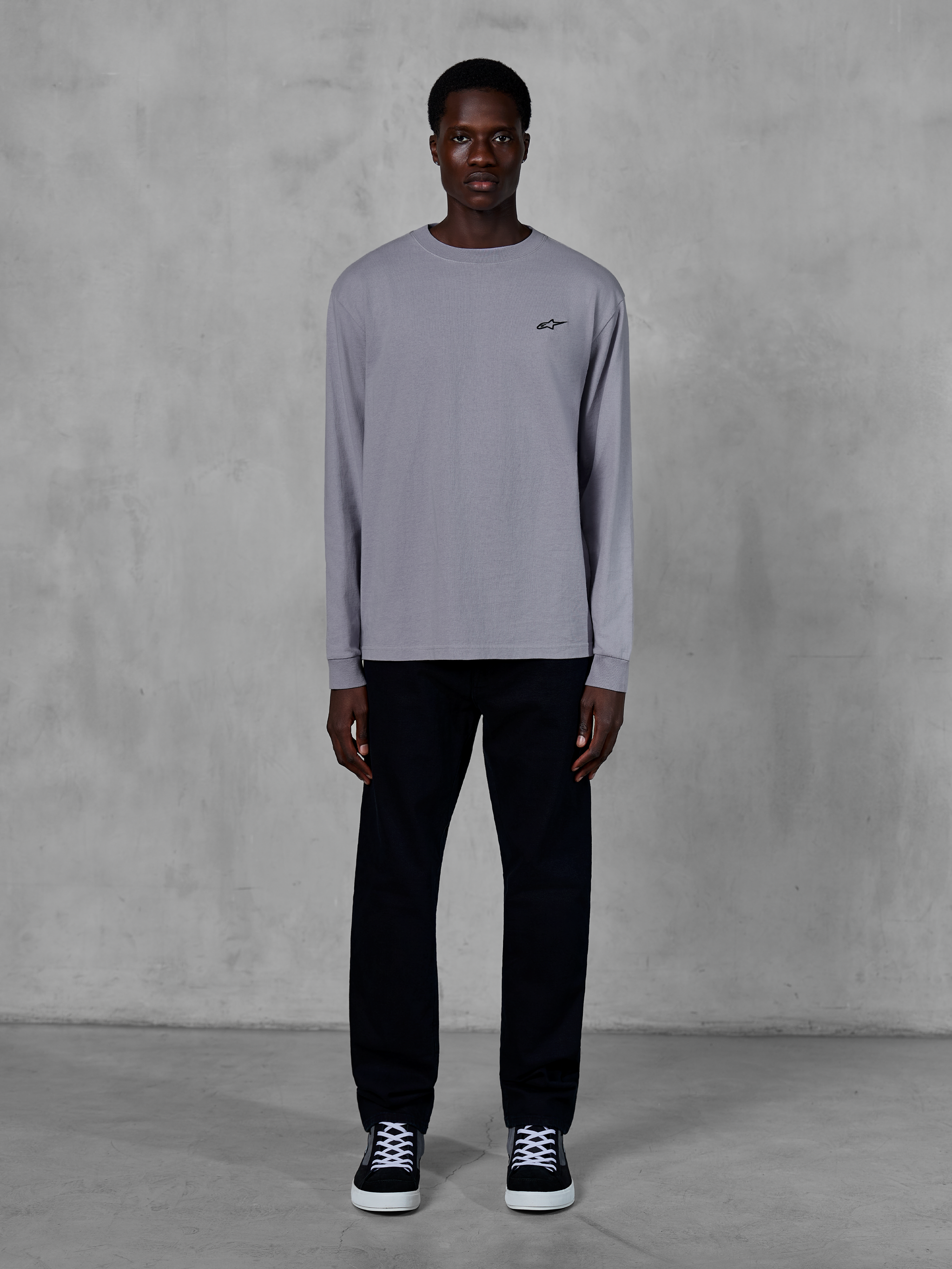 Alpinestars Essentials Ageless LS Tee, Long Sleeve T-Shirt, Silver, small black Alpinestars logo on the chest, organic cotton jersey with stone wash finish, worn by a model with black pants and sneakers, casual streetwear