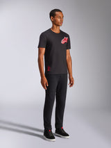 Alpinestars Shaded CSF Tee, Short Sleeve T-Shirt, Black, Red and White Slanted Gradient Foil Astars Logo, Casual Motorsport Streetwear, full-length shot of a model wearing black pants and sneakers