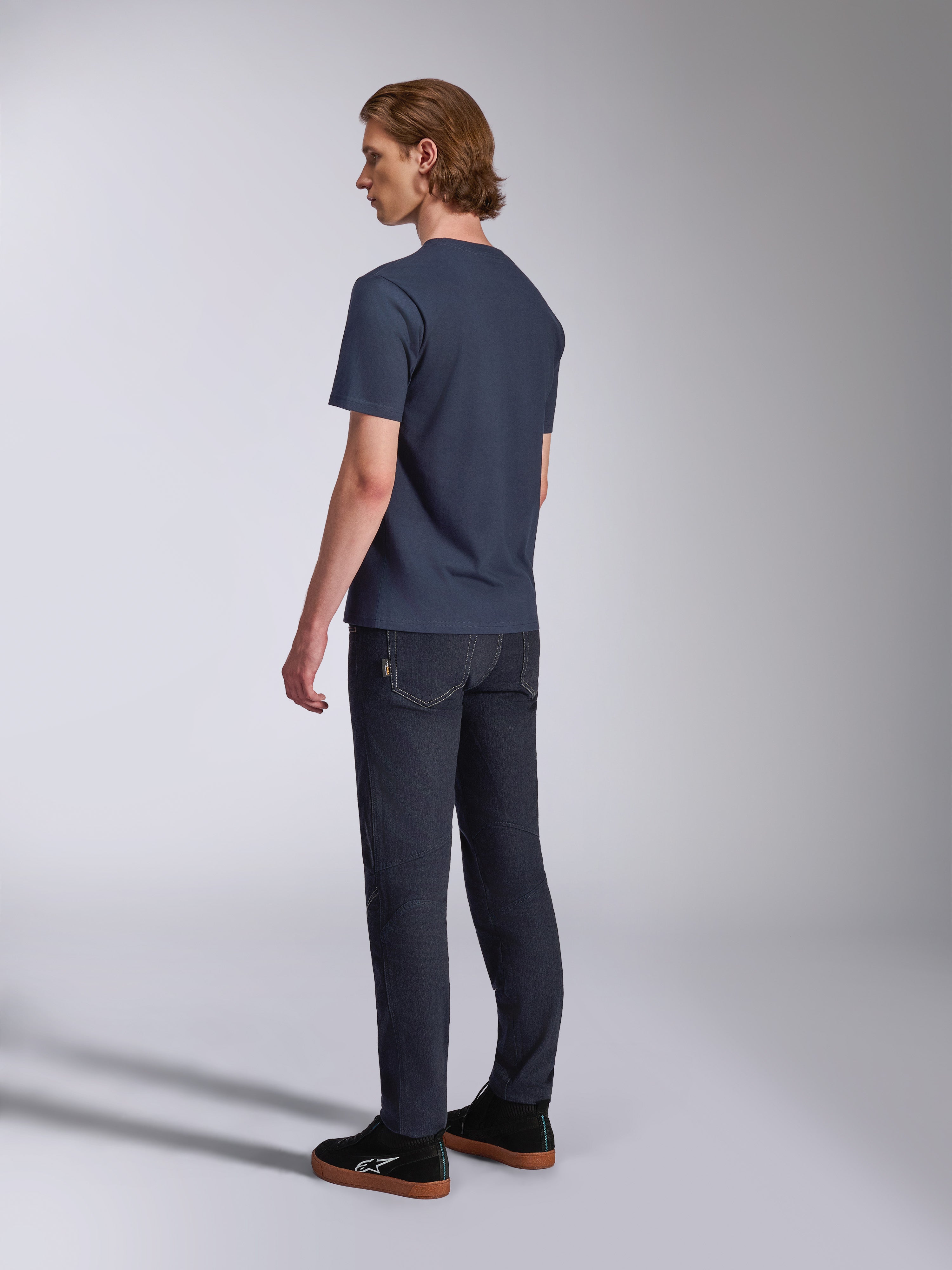Alpinestars Fasting CSF Tee, Short Sleeve T-Shirt, Navy Blue, back view on model, paired with dark denim pants and black sneakers, casual motorsport-inspired streetwear