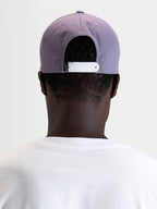 Alpinestars Ageless Snapback Hat, sportswear cap worn from the back showing the adjustable white snapback closure and structured dusty purple crown