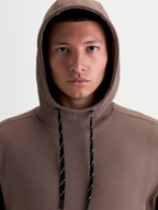 Alpinestars Camino Textured Oversized Hoodie, Casual Sportswear Pullover, Men and Women, Brown Taupe, Textured Knit Twill Fleece with High Collar and Two-Tone Drawcords, Close-Up View on Model