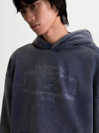 Alpinestars Infinite Washed Oversized Hoodie, Sportswear Pullover for Men and Women, Washed Navy Blue, featuring a snow-wash finish and detailed embroidered chest graphic with technical riding wear branding, oversized fit fleece construction.