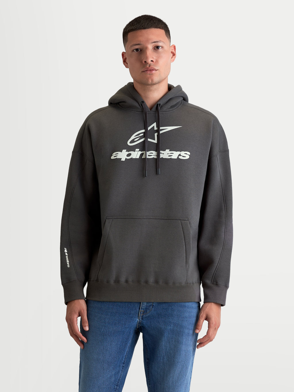Alpinestars Prelude Oversized Hoodie, Men's Sportswear Fleece Pullover, Charcoal Gray and White, Cotton and Recycled Polyester, features a relaxed oversized fit, kangaroo pocket, and bold puff-print logos on chest and sleeve.